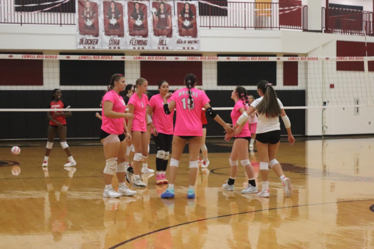 The team being together and representing the cancer awareness with  pink jerseys.