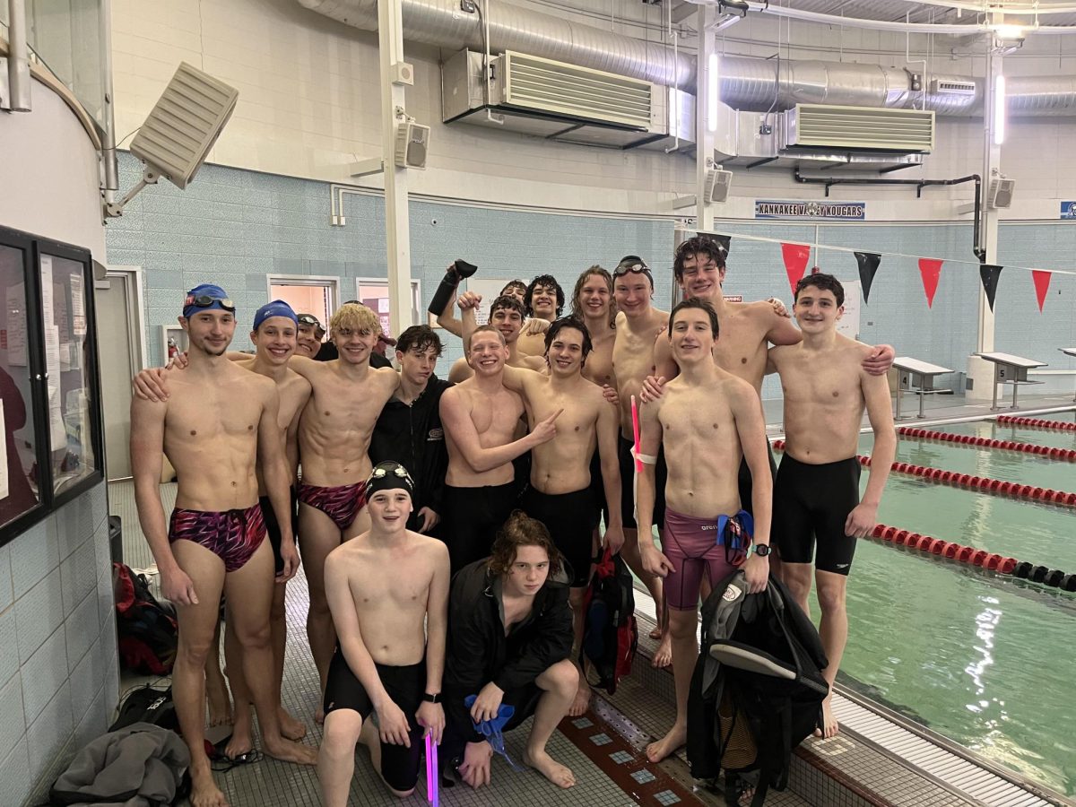 Lowell boys swim team groups up for a team photo after practice.