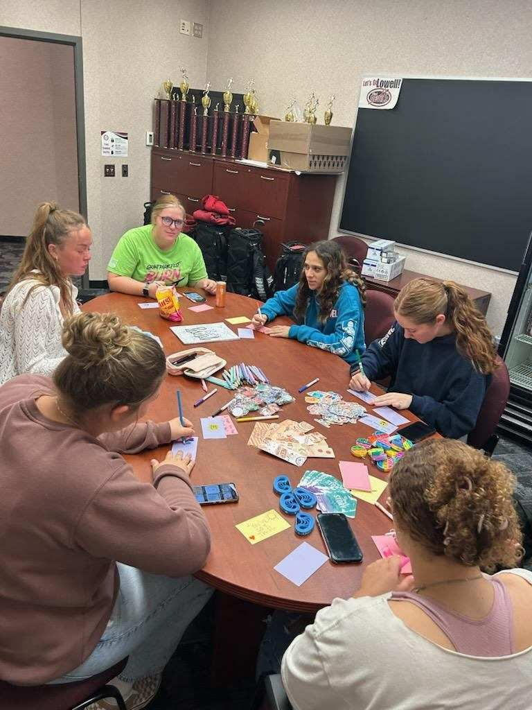 Members of the Sunshine Club gather around at a table creating positivity every minute.