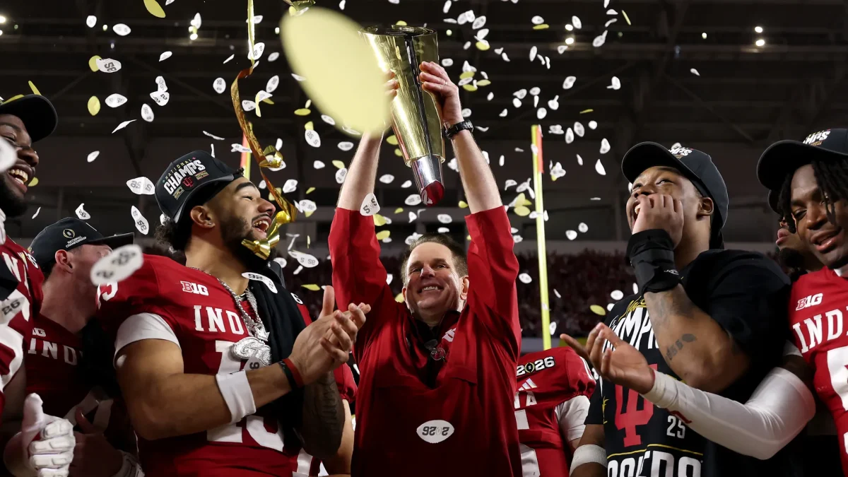Coach Cignetti holds up the Championship trophy