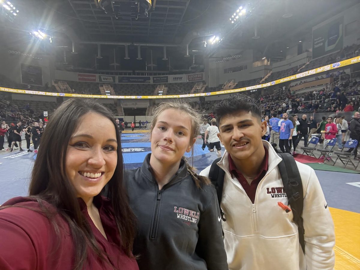 Coaches Michelle English, Andres Mallory, and wrestler Alexia Utley at state. 