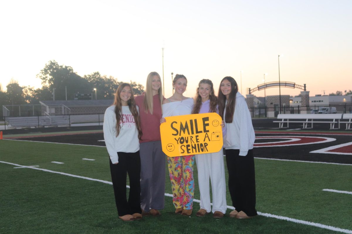 Senior Smiles: Five friends come together to capture a memory at Senior Sunrise as their smiles light up the morning. This moment marked the start of their final year together.