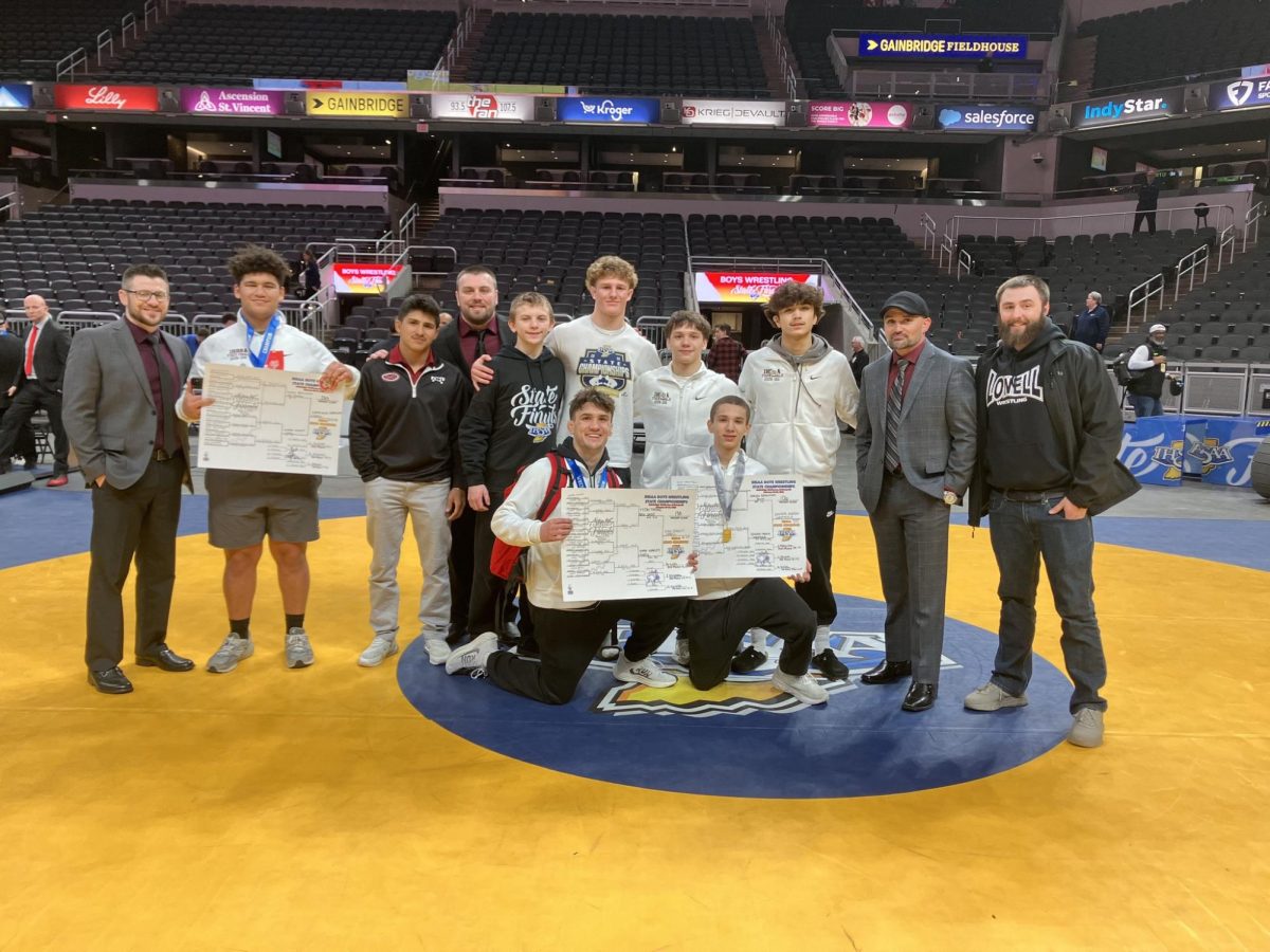 The 2026 LHS state-qualifying wrestlers and their coaches pose proudly for a photo.