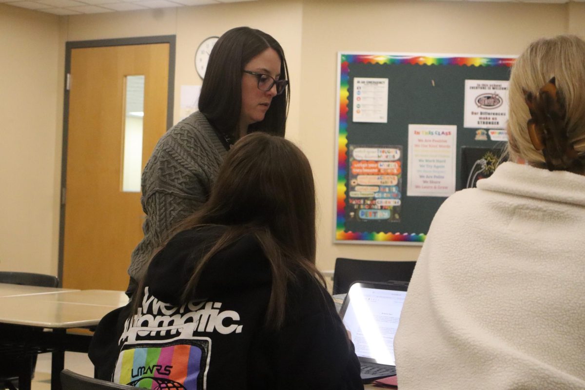 Ms. McAllister, the AP Seminar teacher, helps sophomore Mya Whaley as she researches for her project.