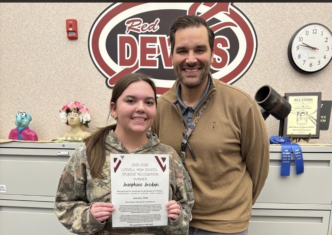 Freshman Josephine Jordan poses with Mr. G to accept her Student of the Month award.