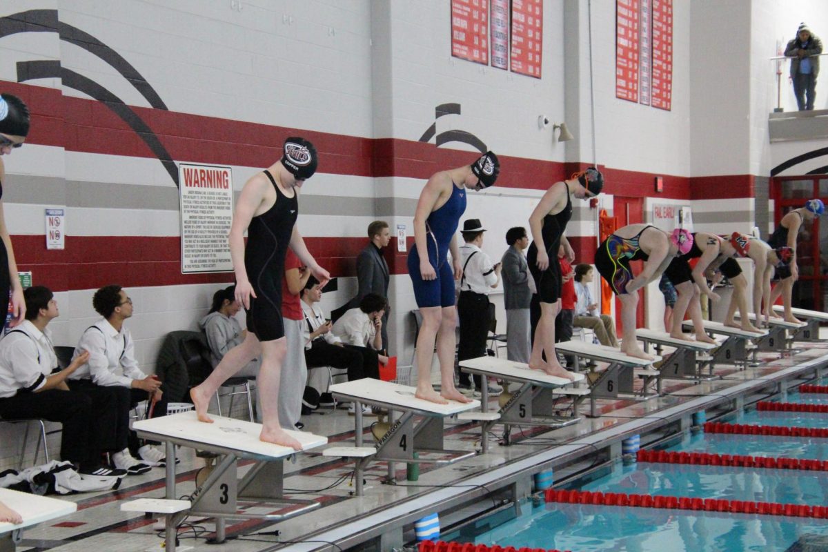 Senior Cali Kissel and Junior Riley Copper get ready to start their meet. They aim to place high and beat their previous records. 