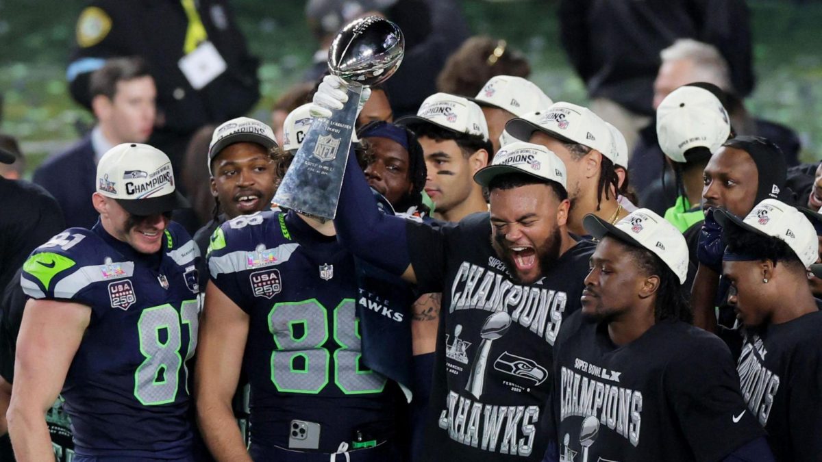 Seattle Seahawks players celebrate with the Lombardi Trophy.