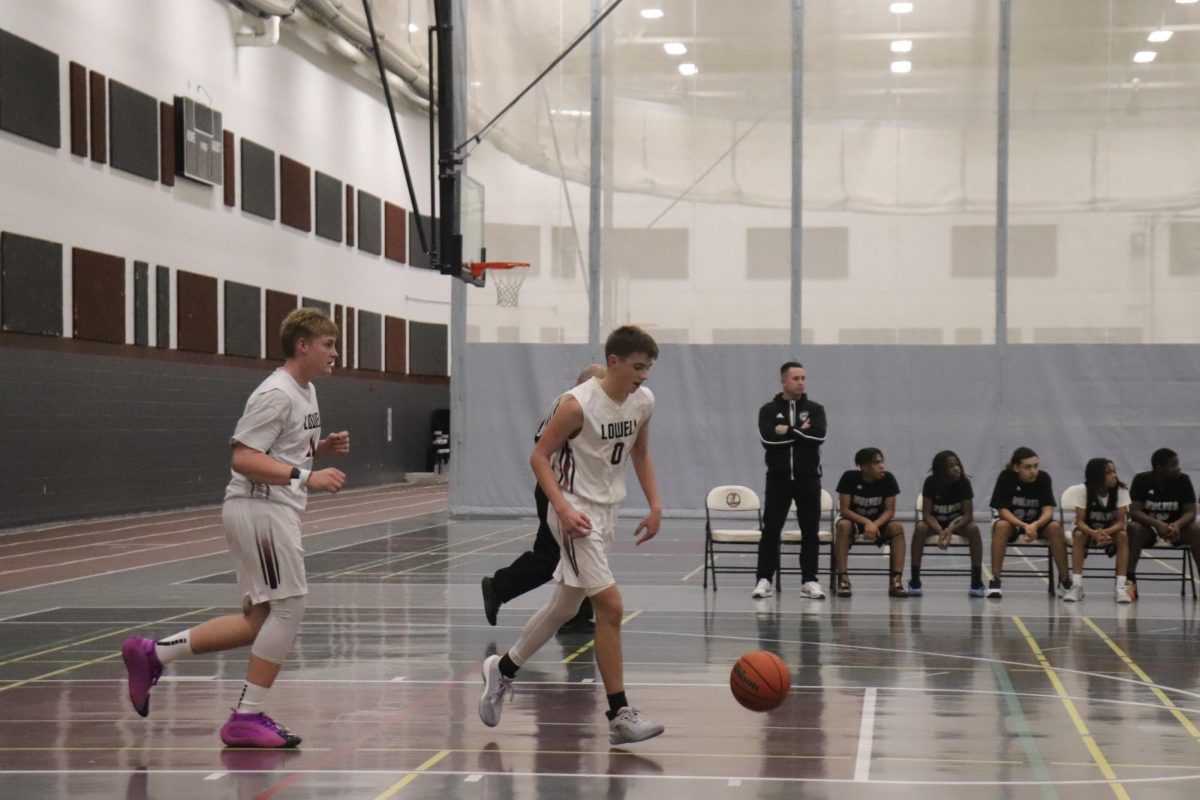 Freshman Frank Surdyk takes the ball down the court. He runs the point an commands the offense. 