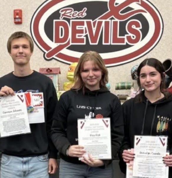 Kira Kirk, pictured in the middle, poses with others who won the title of "Student of the Month."
