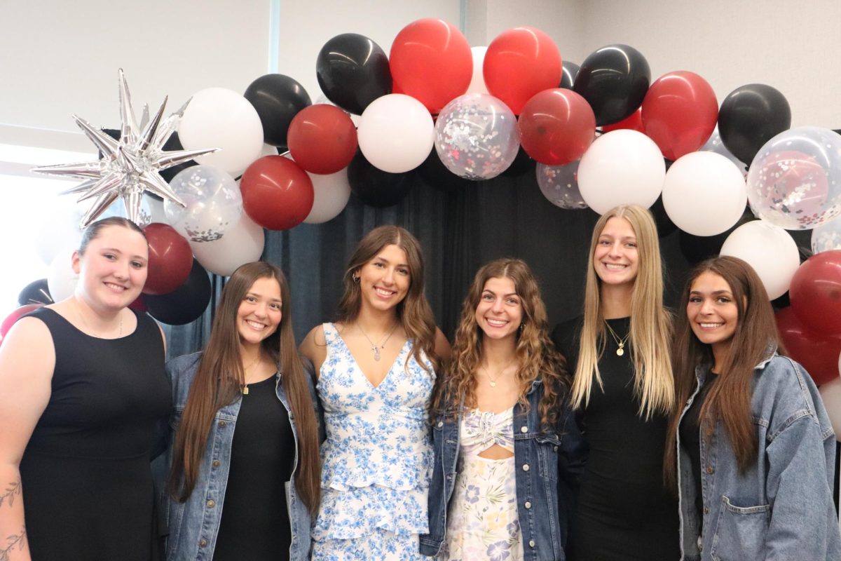 The senior softball players pose for a photo on their senior night team dinner. 
