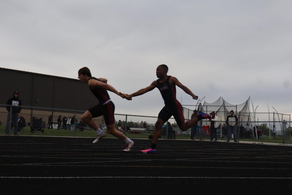 Junior Michael Montgomery passes off the baton to senior Roan Vasko. This helped with the win against Hanover