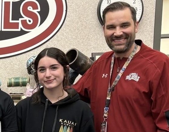 Emmalyn poses next to Mr. Goeringer after being named "April Student of the Month."