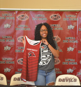 Ally holds up her IUN Cross Country Uniform.